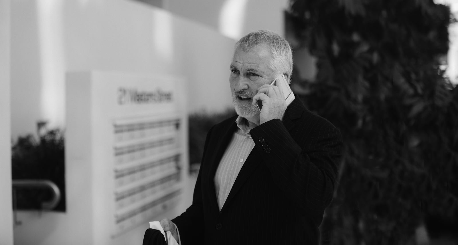 Photo of John Sage, property developer and investor, on the phone with a client